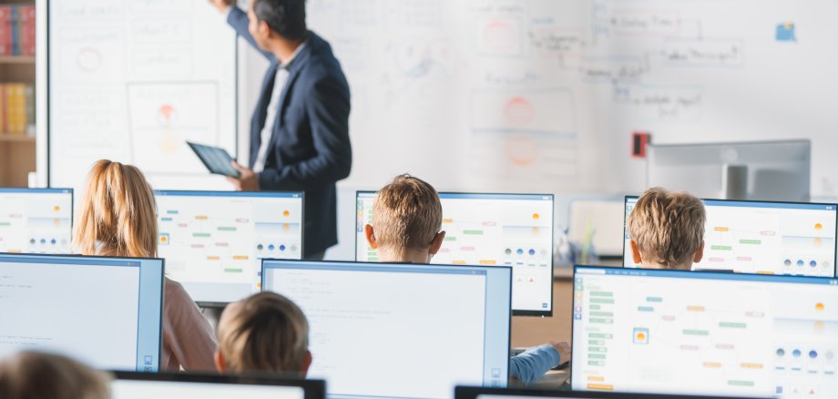 Elementary School Class: Teacher Uses Interactive Digital Whiteboard, Explains Lesson to Diverse Group of Smart Children. Kids getting Modern Education, Learn Computer Science, Software Programming Elementary School Class: Teacher Uses Interactive Digital Whiteboard, Explains Lesson to Diverse Group of Smart Children. Kids getting Modern Education, Learn Computer Science, Software Programming